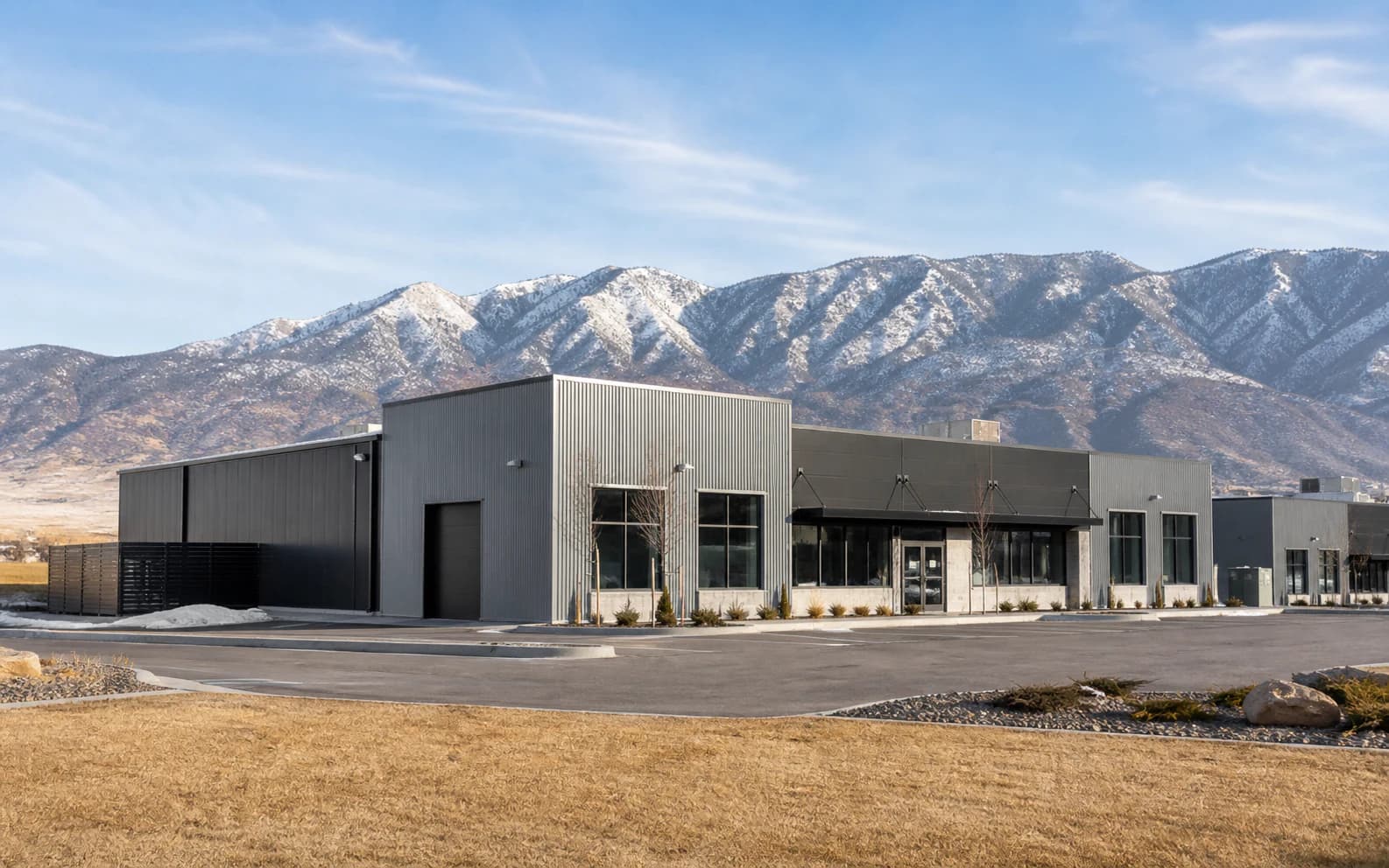 Illustration of industrial buildings beneath mountains